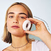 Young woman using ZIIP DOT white acne device
